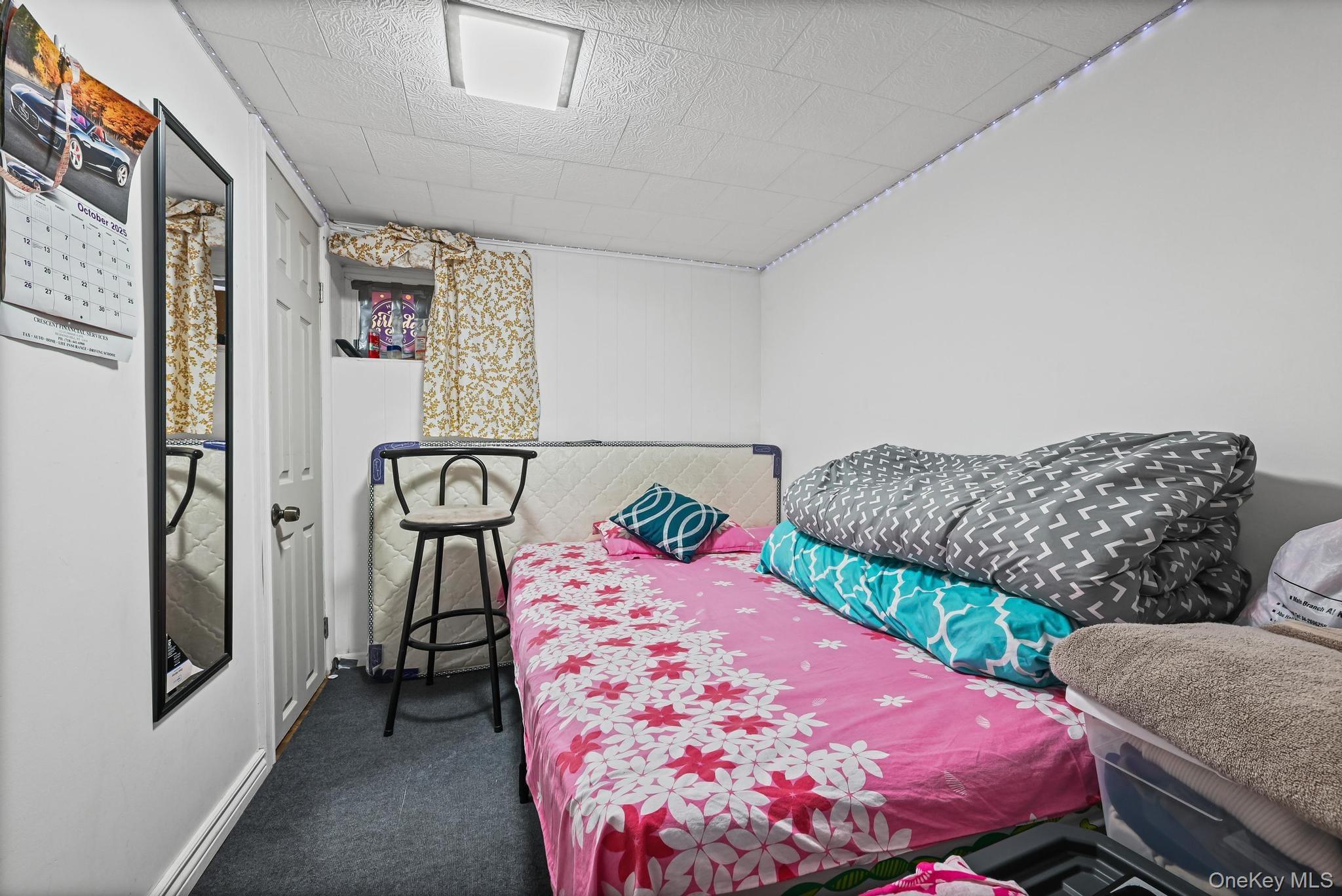 90-16 76th Street Queens, NY 11421 - Photo 20 of 28 a bedroom with a bed and dresser