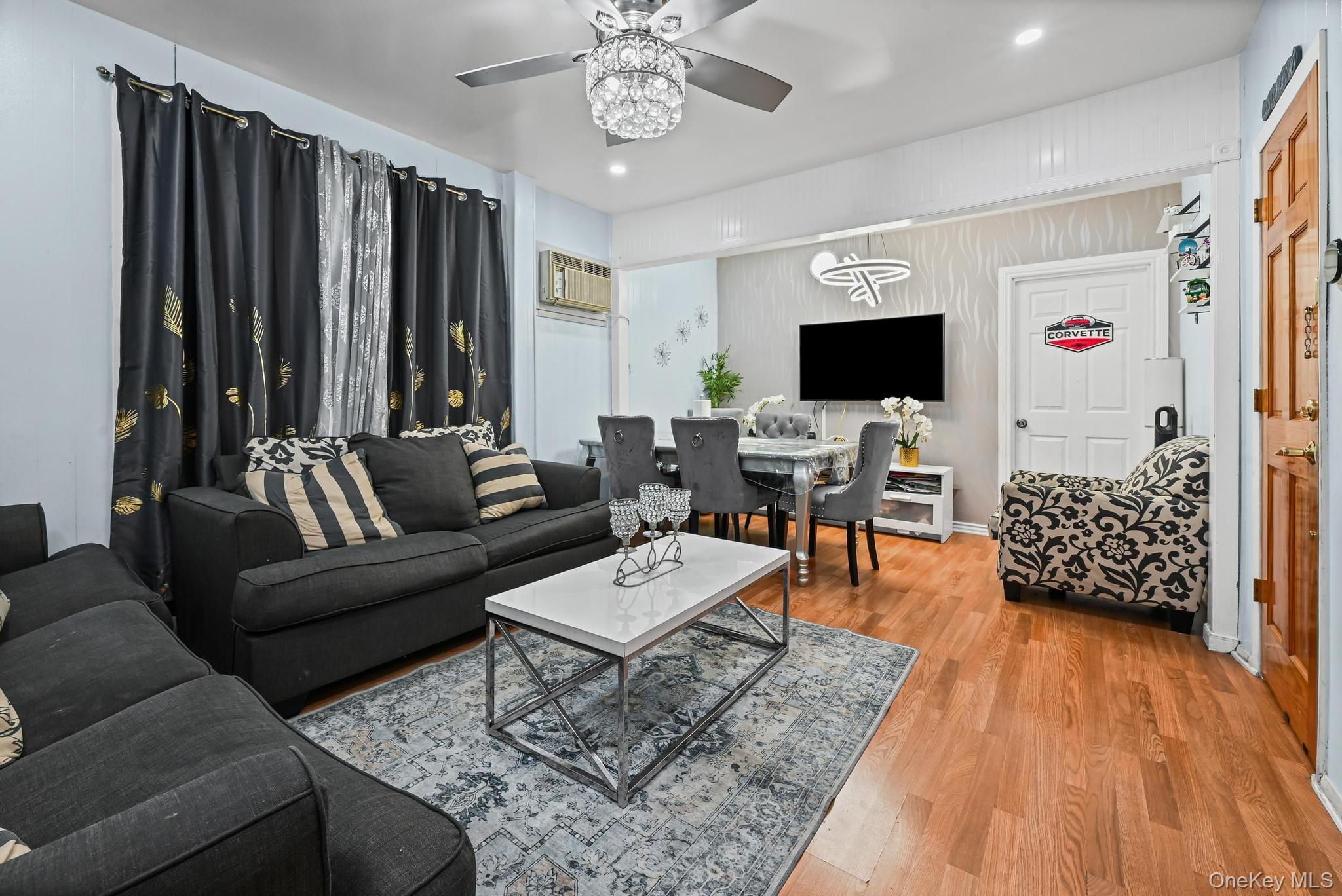 90-16 76th Street Queens, NY 11421 - Photo 2 of 28 a living room with furniture and wooden floor
