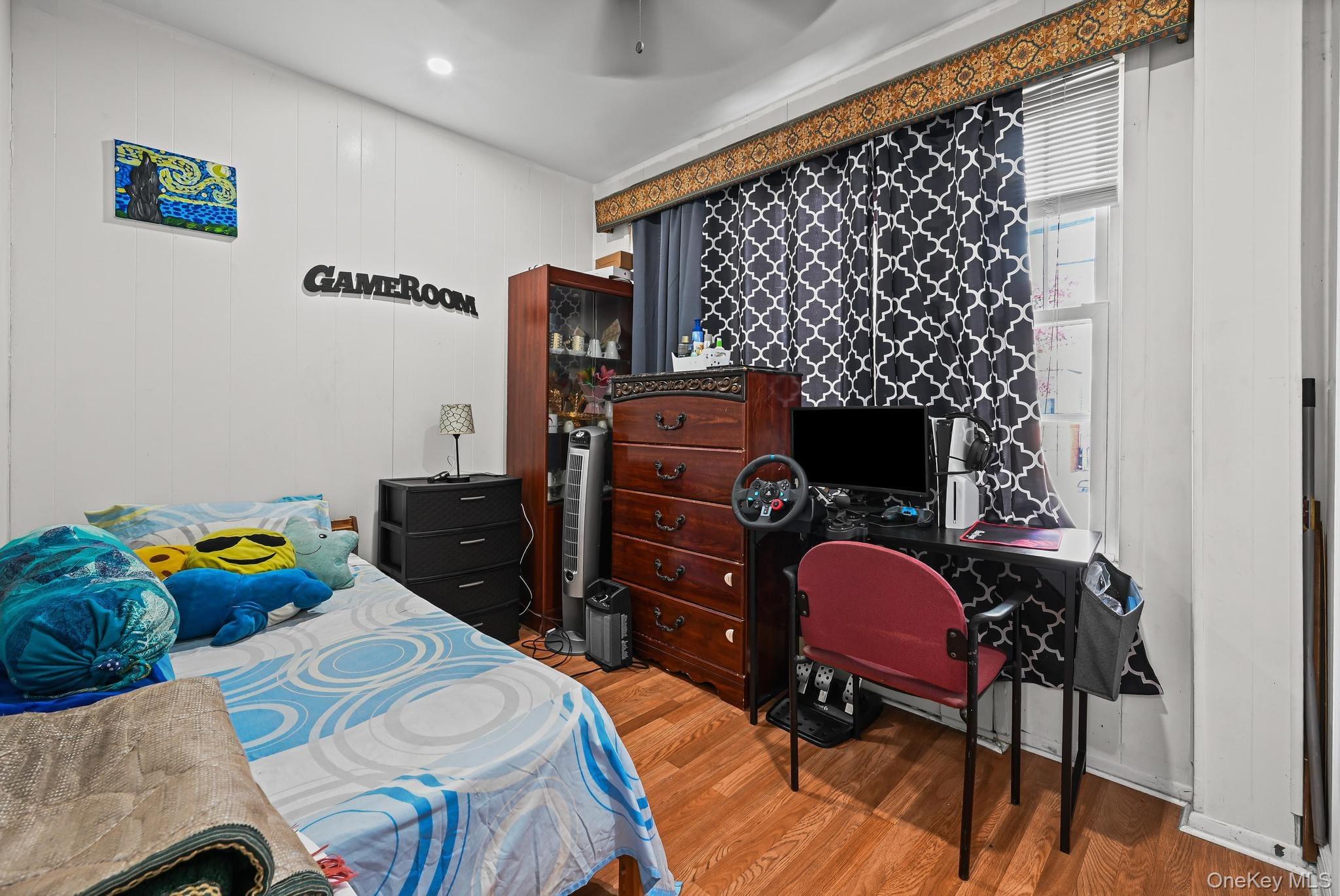 90-16 76th Street Queens, NY 11421 - Photo 21 of 28 a bedroom with a bed and a chair