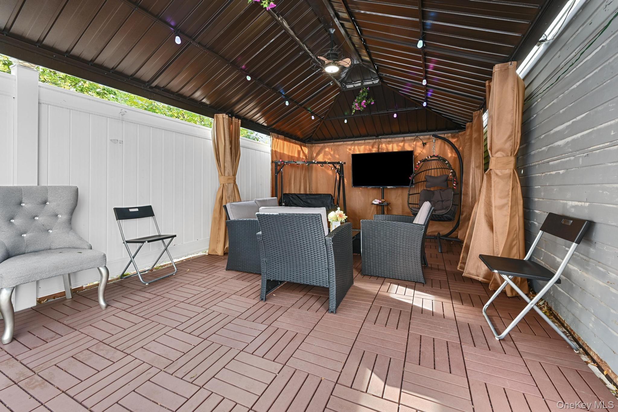 90-16 76th Street Queens, NY 11421 - Photo 26 of 28 a view of a chairs and table in a patio