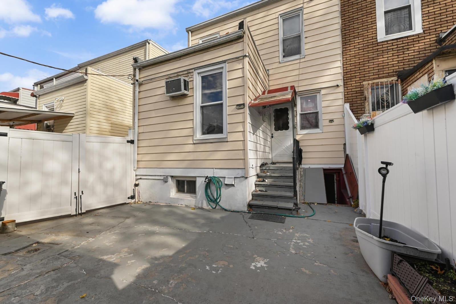 90-16 76th Street Queens, NY 11421 - Photo 28 of 28 a view of a house with a garage