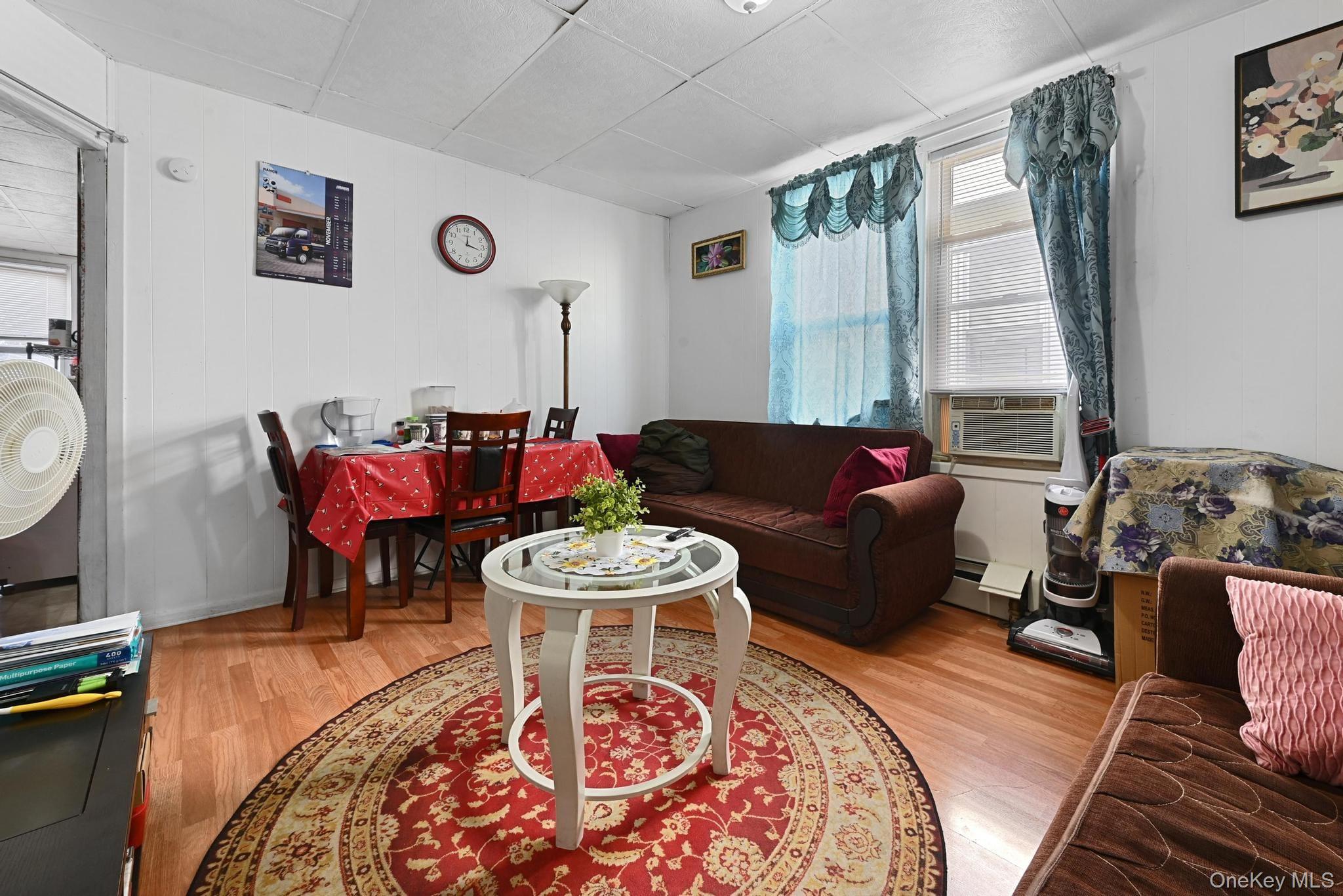 90-16 76th Street Queens, NY 11421 - Photo 3 of 28 a living room with furniture and a large window