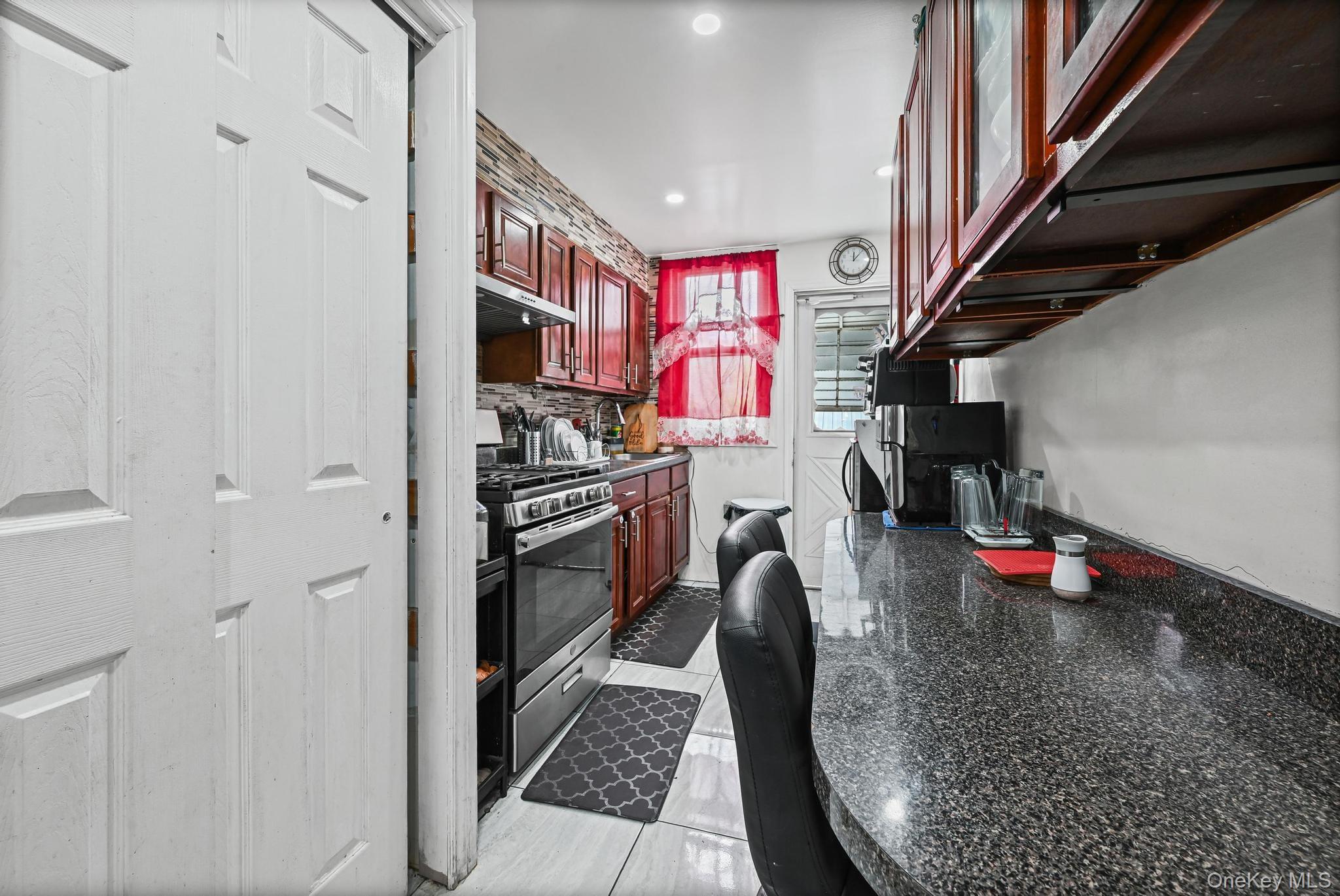 90-16 76th Street Queens, NY 11421 - Photo 6 of 28 a kitchen view with stainless steel appliances a refrigerator and a sink