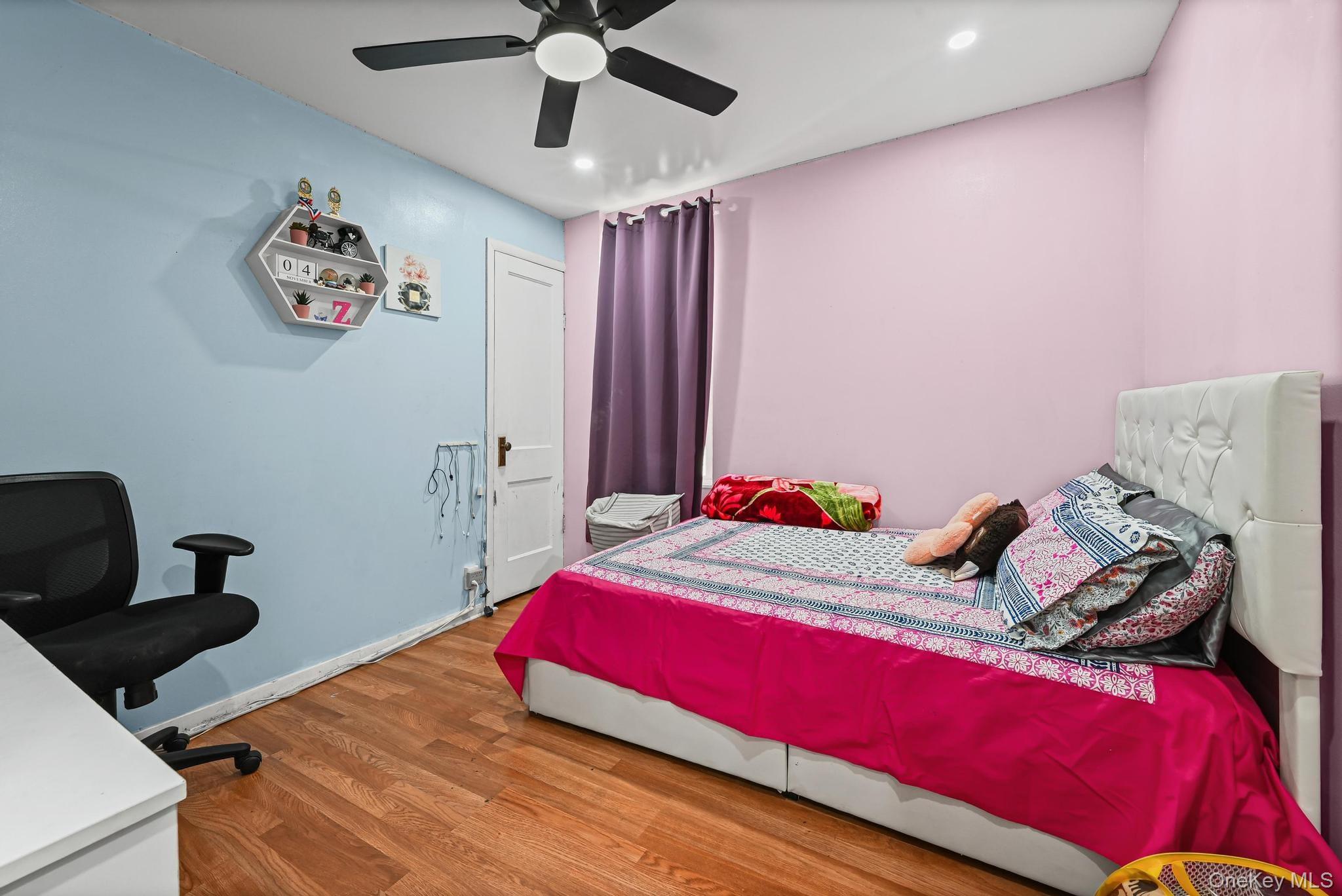 90-16 76th Street Queens, NY 11421 - Photo 10 of 28 a bedroom with a bed and a chandelier