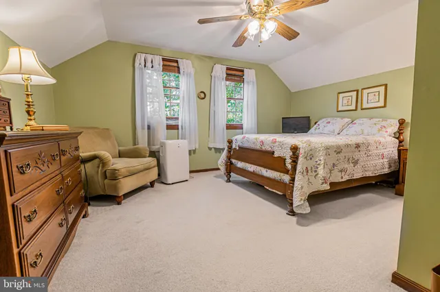 a spacious bedroom with a bed and a chandelier