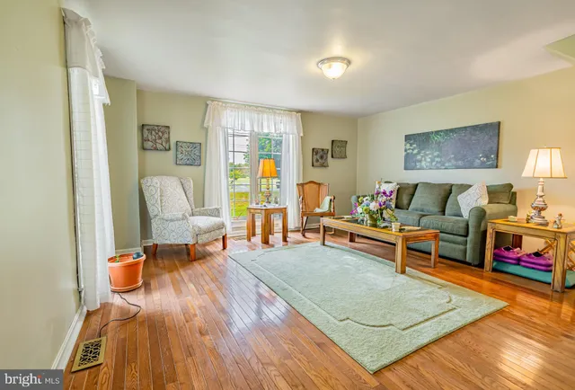 a living room with furniture and kitchen view