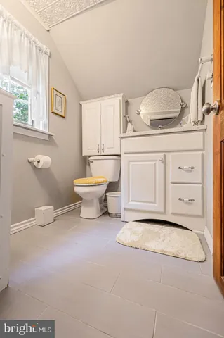 a bedroom with a bed and a flat tv screen on the dresser