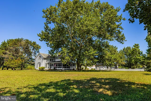 a front view of a house with a big yard