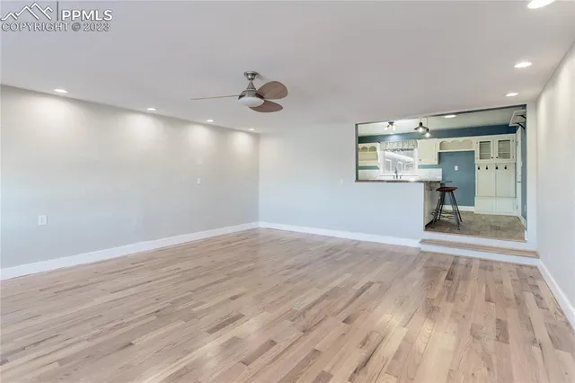 a view of empty room with wooden floor