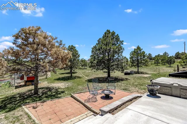 a view of a backyard with sitting area