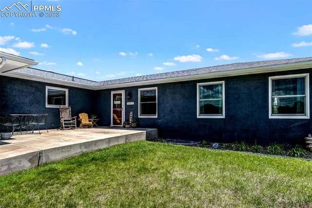 a house view with a sitting space and garden