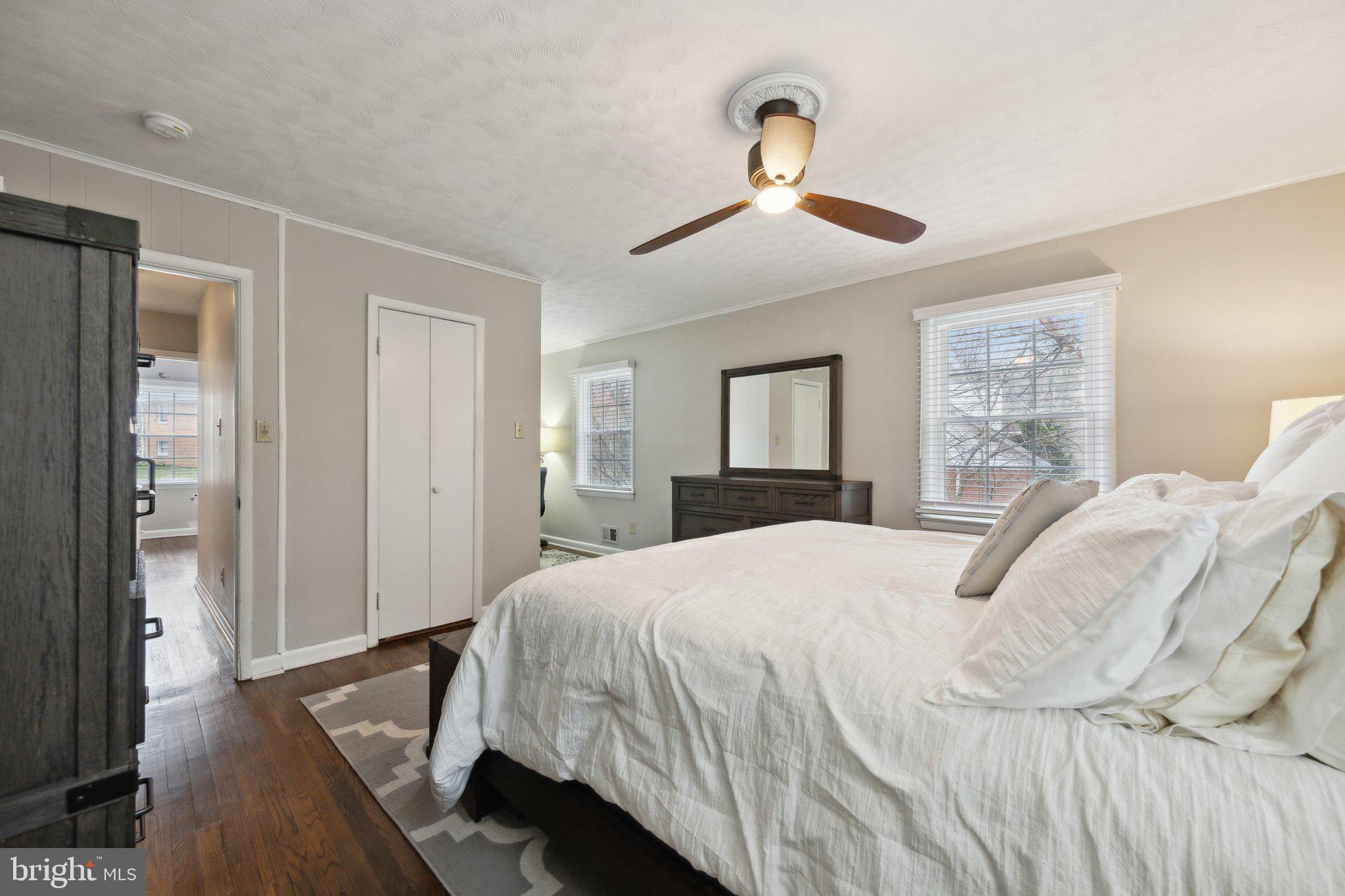 10601 Meadowhill Road Silver Spring, MD 20901 - Photo 11 of 33 a bedroom with a large bed and a chandelier