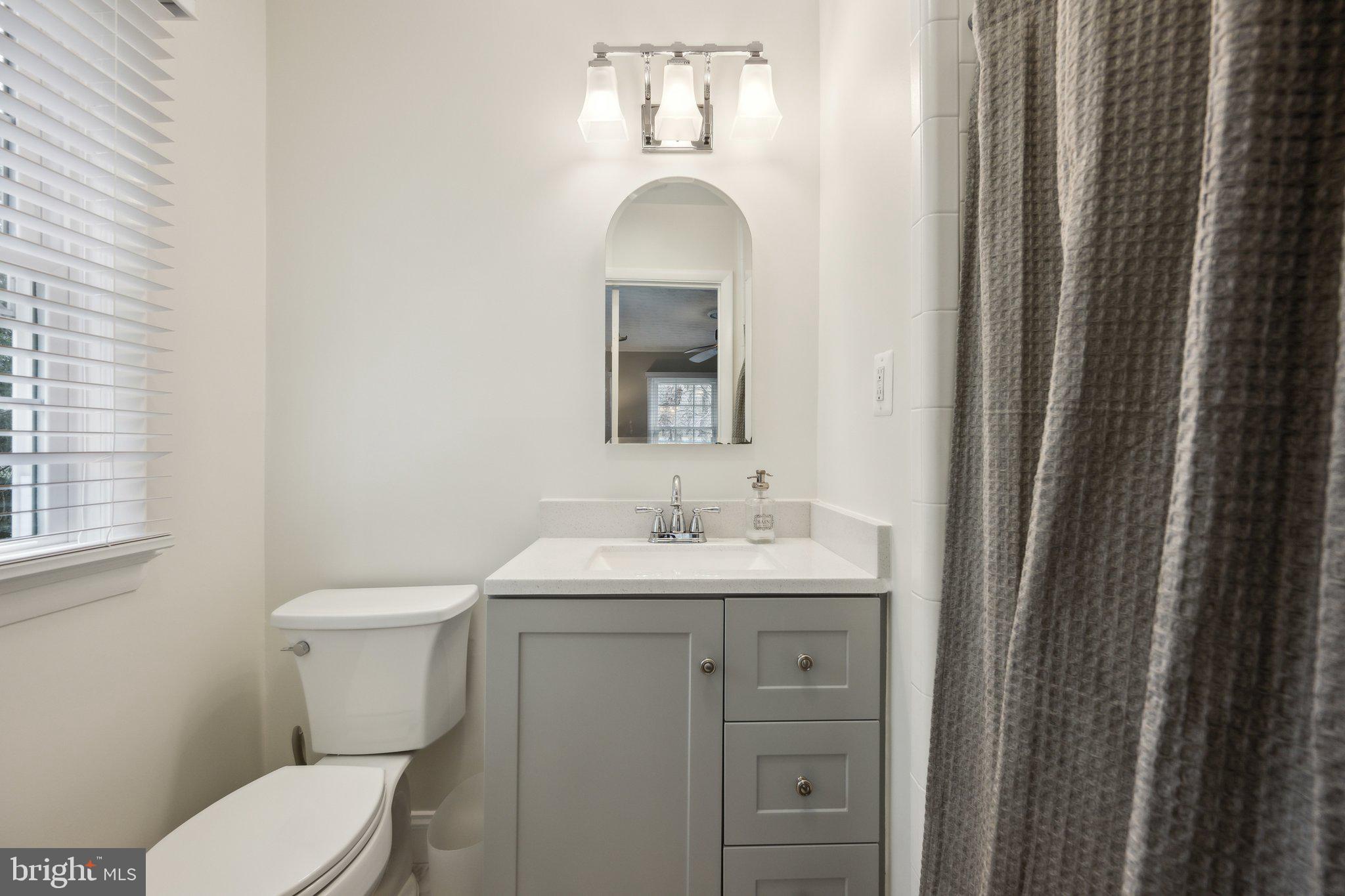 10601 Meadowhill Road Silver Spring, MD 20901 - Photo 13 of 33 a bathroom with a toilet sink and mirror