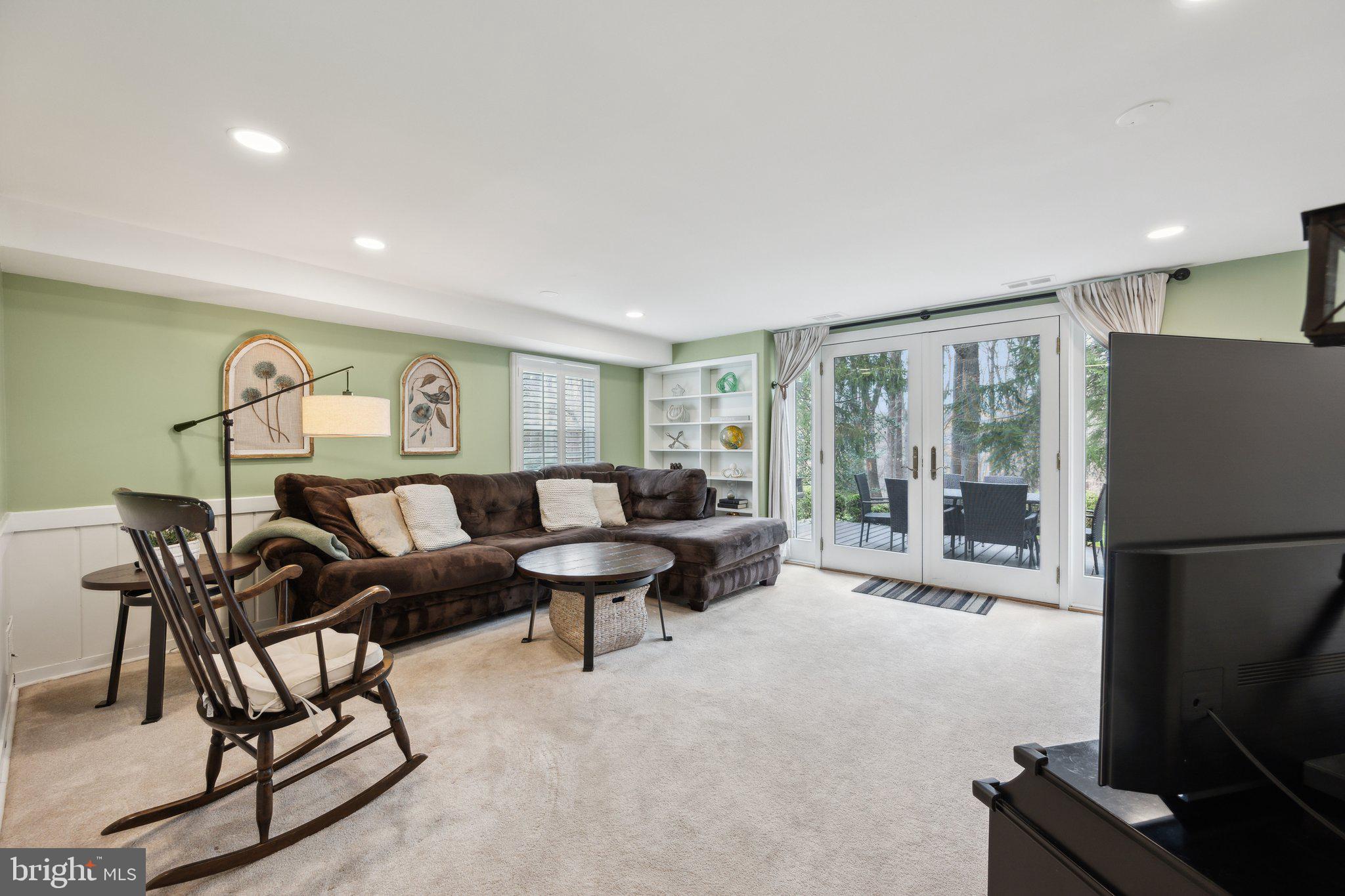 10601 Meadowhill Road Silver Spring, MD 20901 - Photo 18 of 33 a living room with furniture a large window and a flat screen tv