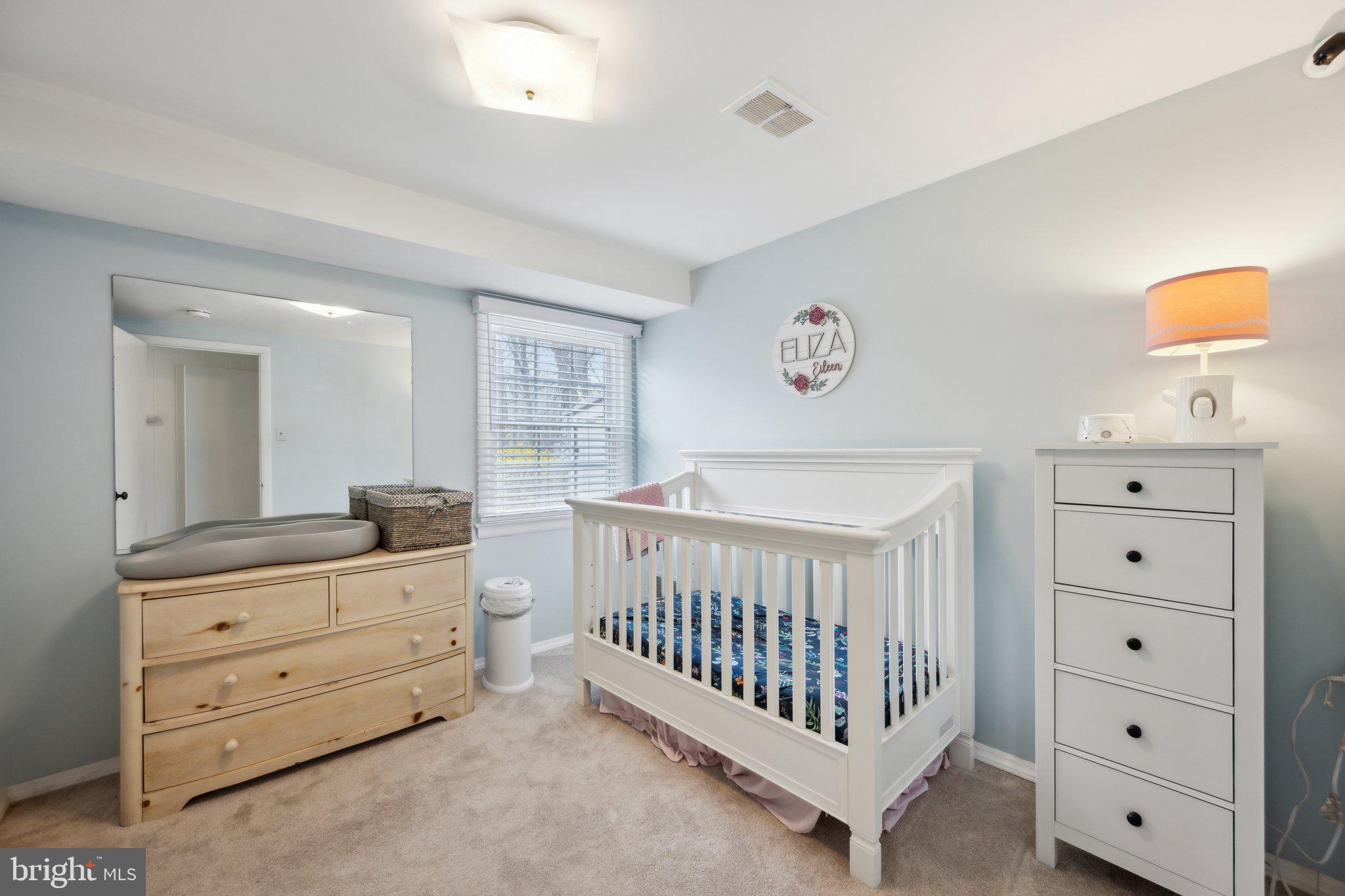 10601 Meadowhill Road Silver Spring, MD 20901 - Photo 21 of 33 a bedroom with a baby bed and a dresser
