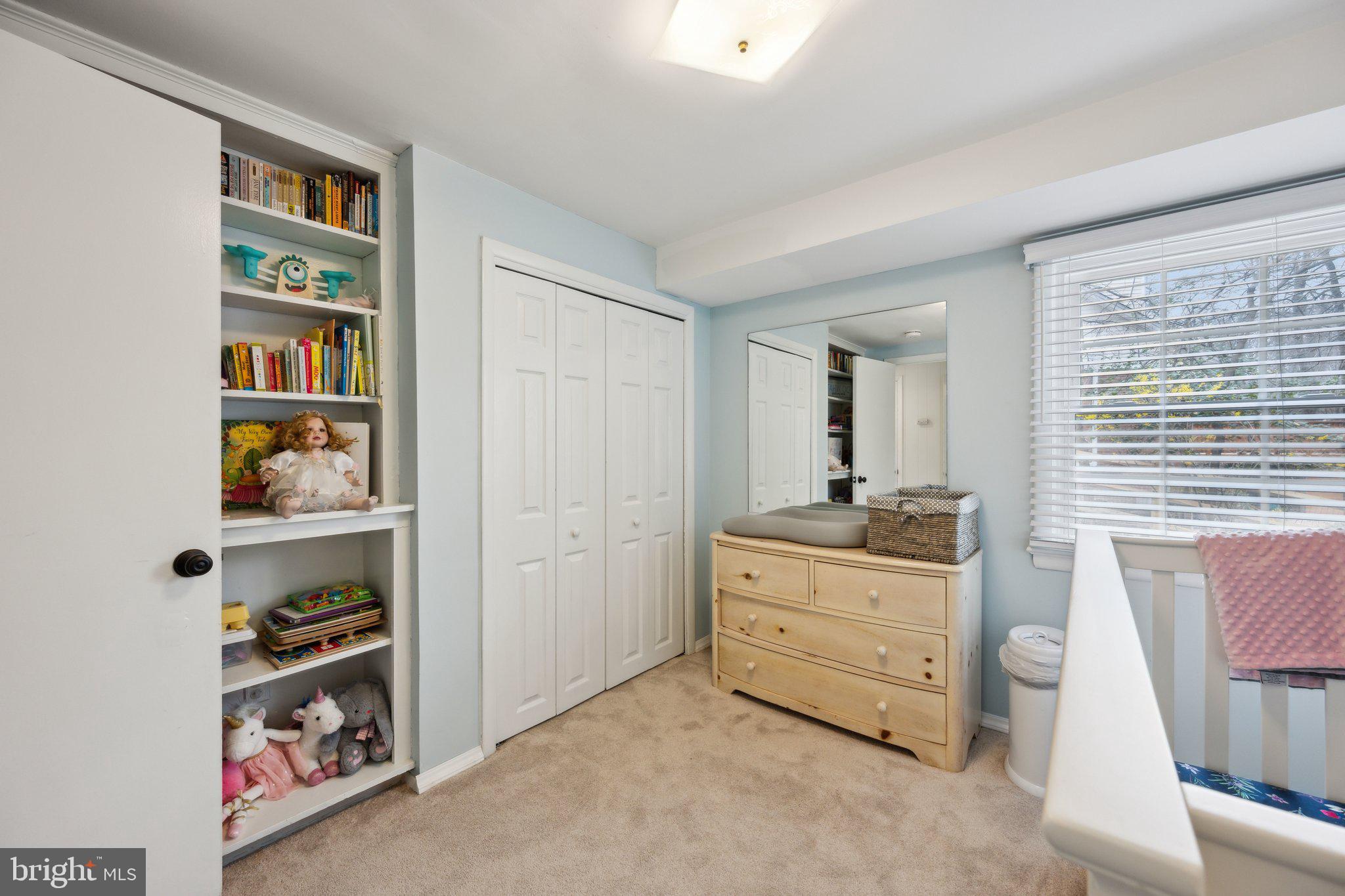 10601 Meadowhill Road Silver Spring, MD 20901 - Photo 22 of 33 a room with a bed and a book shelf