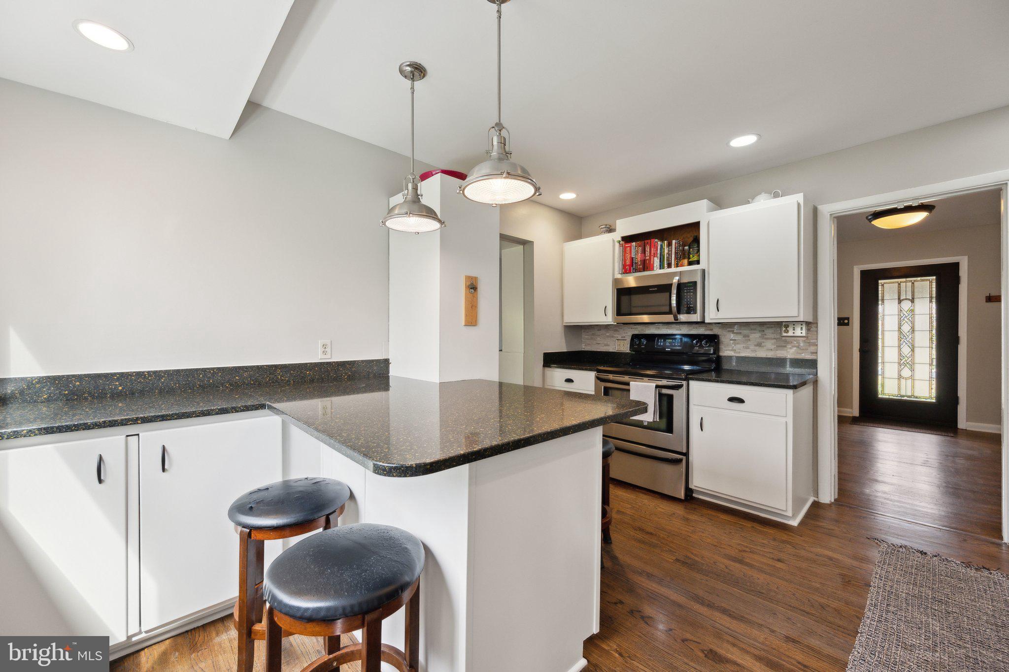 10601 Meadowhill Road Silver Spring, MD 20901 - Photo 9 of 33 a kitchen with stainless steel appliances granite countertop a sink a stove and a wooden floors