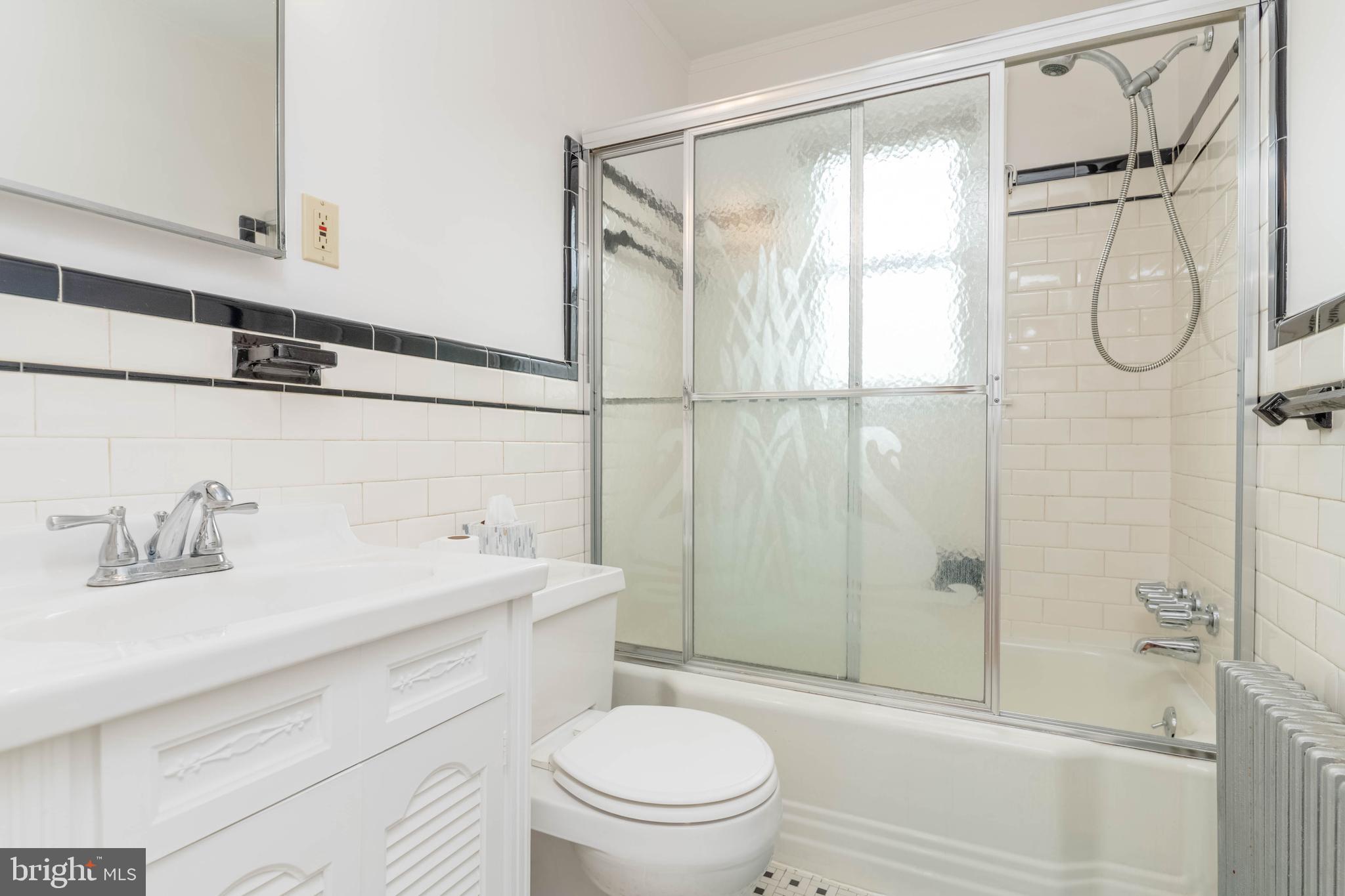 1102 Orems Road Baltimore, MD 21220 - Photo 16 of 46 a bathroom with a granite countertop sink a toilet and shower