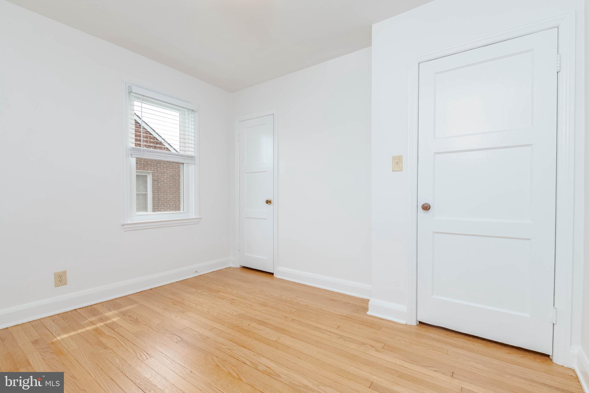 1102 Orems Road Baltimore, MD 21220 - Photo 18 of 46 an empty room with wooden floor and windows