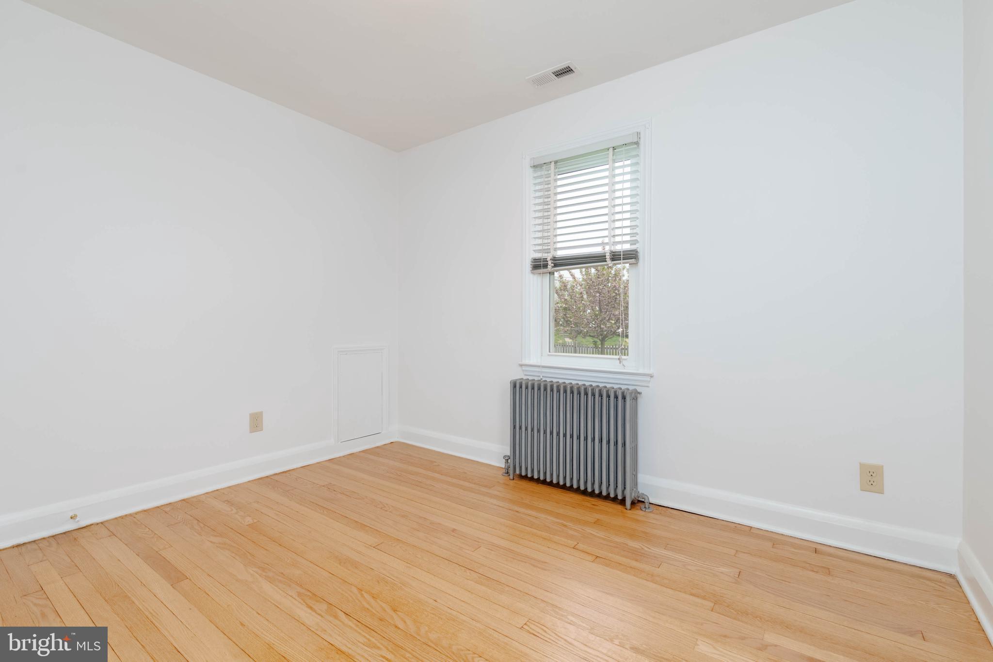 1102 Orems Road Baltimore, MD 21220 - Photo 20 of 46 an empty room with wooden floor and windows