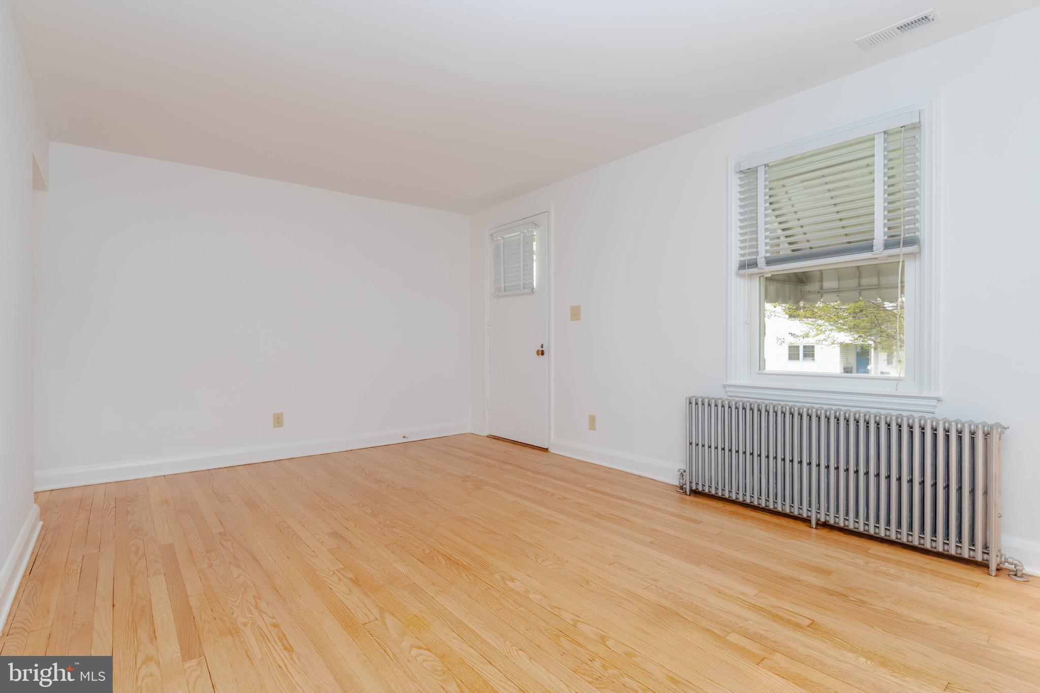 1102 Orems Road Baltimore, MD 21220 - Photo 24 of 46 a view of an empty room with wooden floor and a window