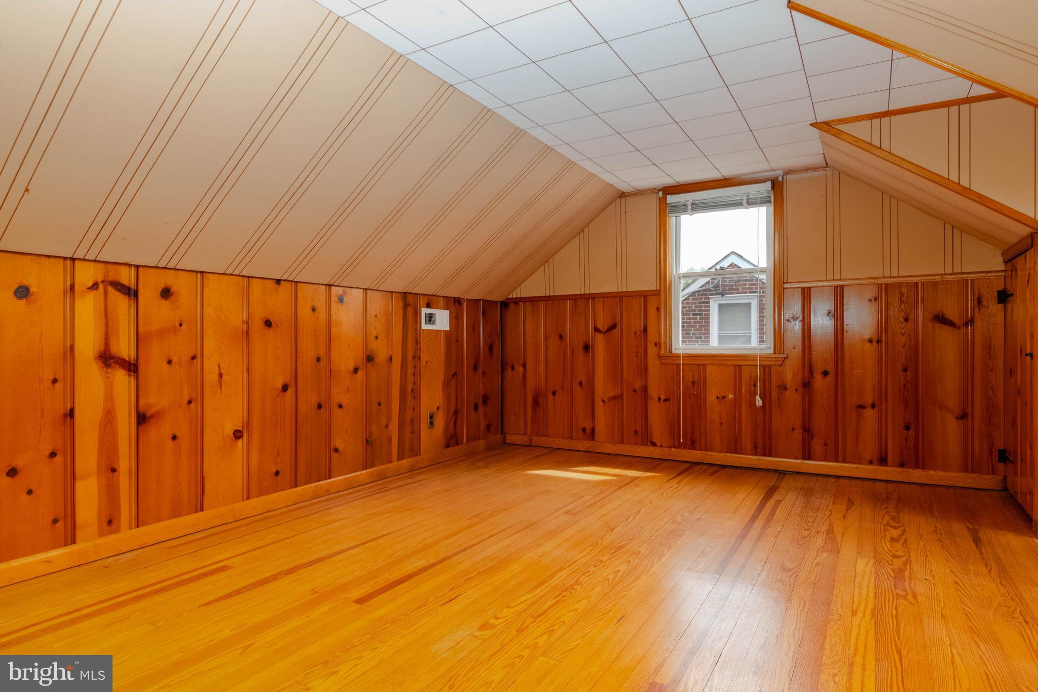 1102 Orems Road Baltimore, MD 21220 - Photo 26 of 46 a view of an empty room with wooden floor and a window