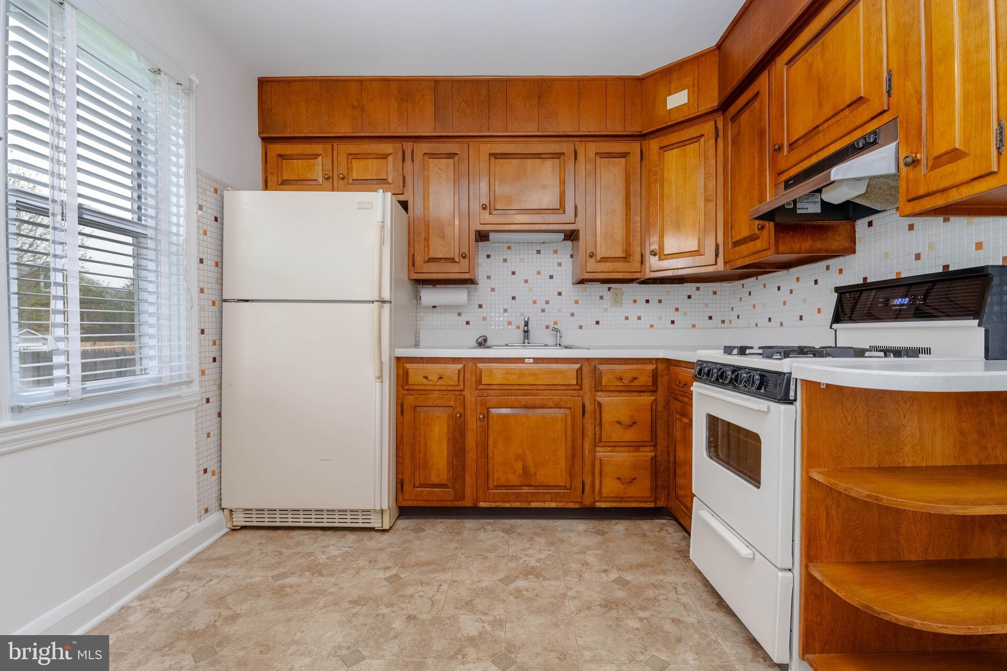 1102 Orems Road Baltimore, MD 21220 - Photo 7 of 46 a kitchen with a white cabinets and white appliances