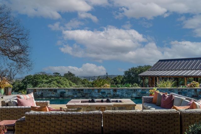 a view of a patio with couches chairs and a potted plant