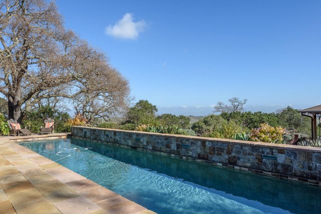a view of a yard with wooden fence