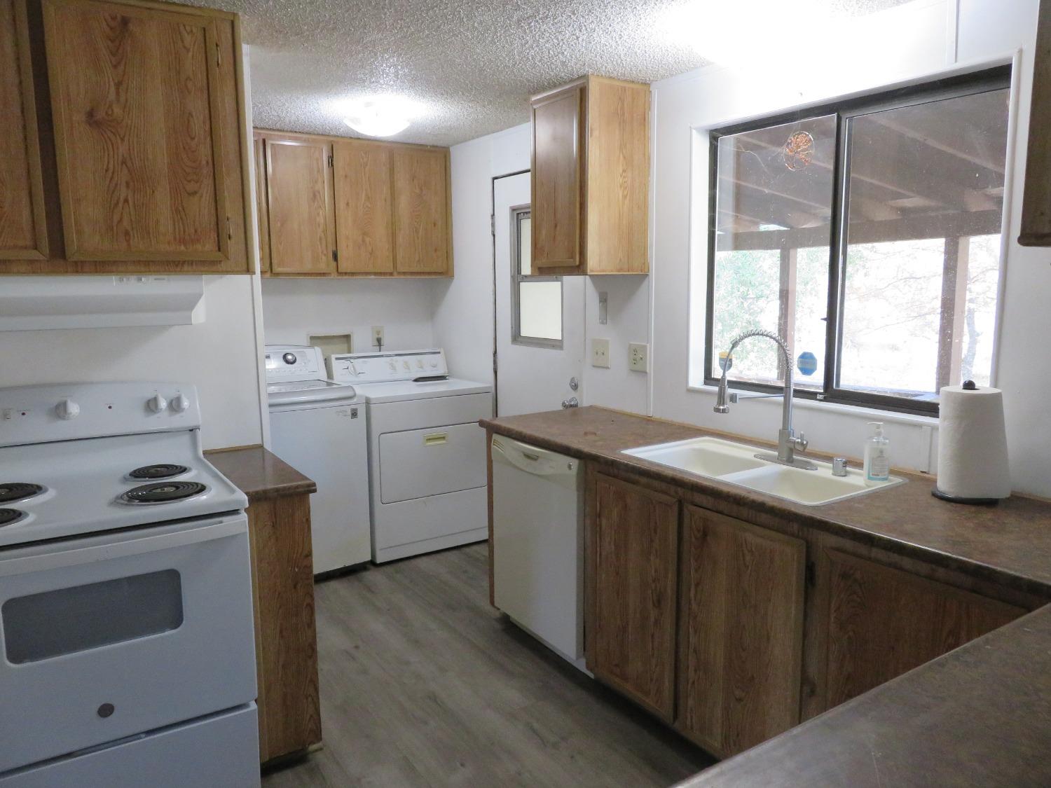 4426 Bald Mountain Road West Point, CA 95255 - Photo 24 of 45 a kitchen with a sink stove and cabinets