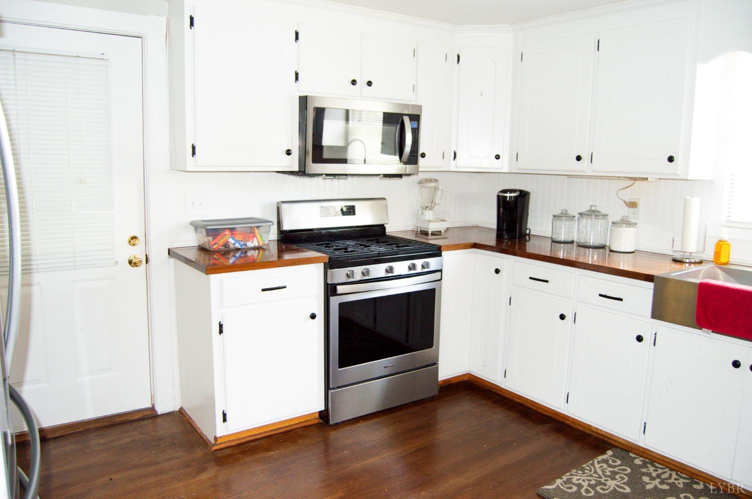 4740 Payneton Road Chatham, VA 24531 - Photo 21 of 49 a kitchen with granite countertop white cabinets and white appliances