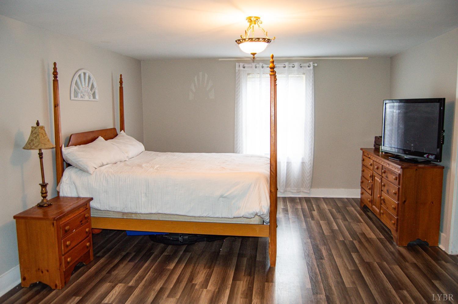 4740 Payneton Road Chatham, VA 24531 - Photo 28 of 49 a bedroom with a bed and wooden floor