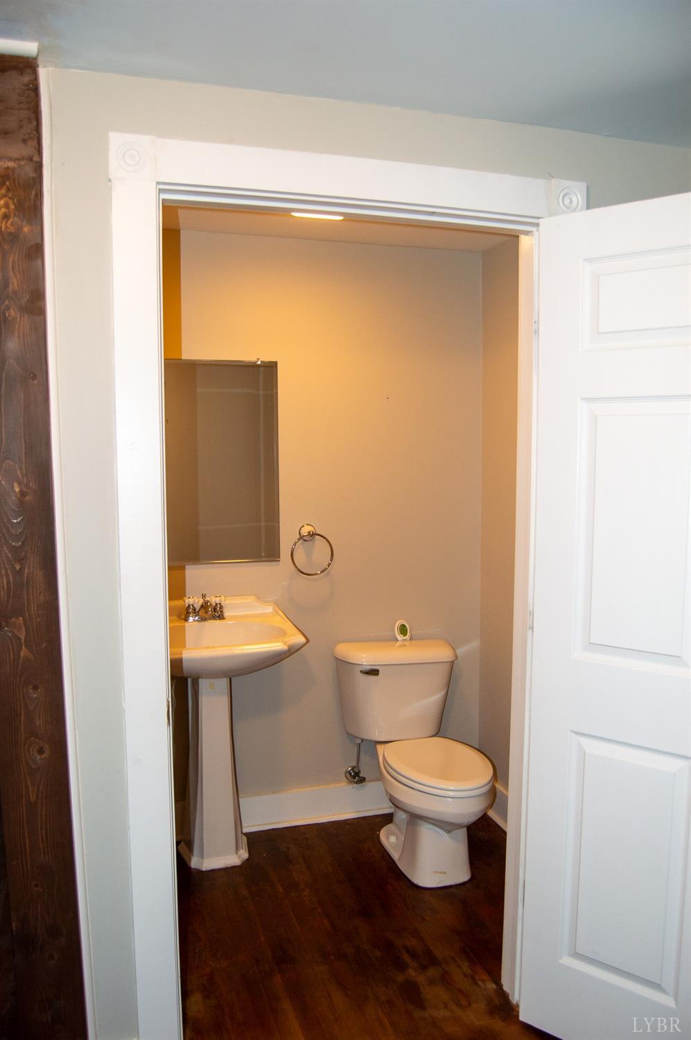4740 Payneton Road Chatham, VA 24531 - Photo 34 of 49 a bathroom with a toilet a sink and mirror