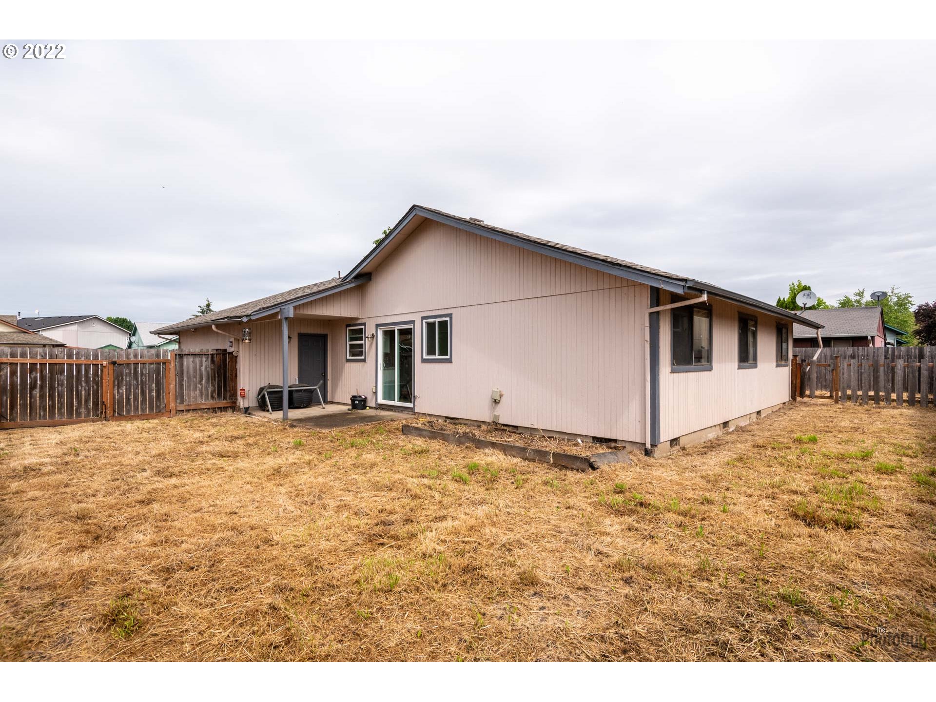 529 Sandstone Way Eugene, OR 97402 - Photo 19 of 19 a big house with a big yard and large tree