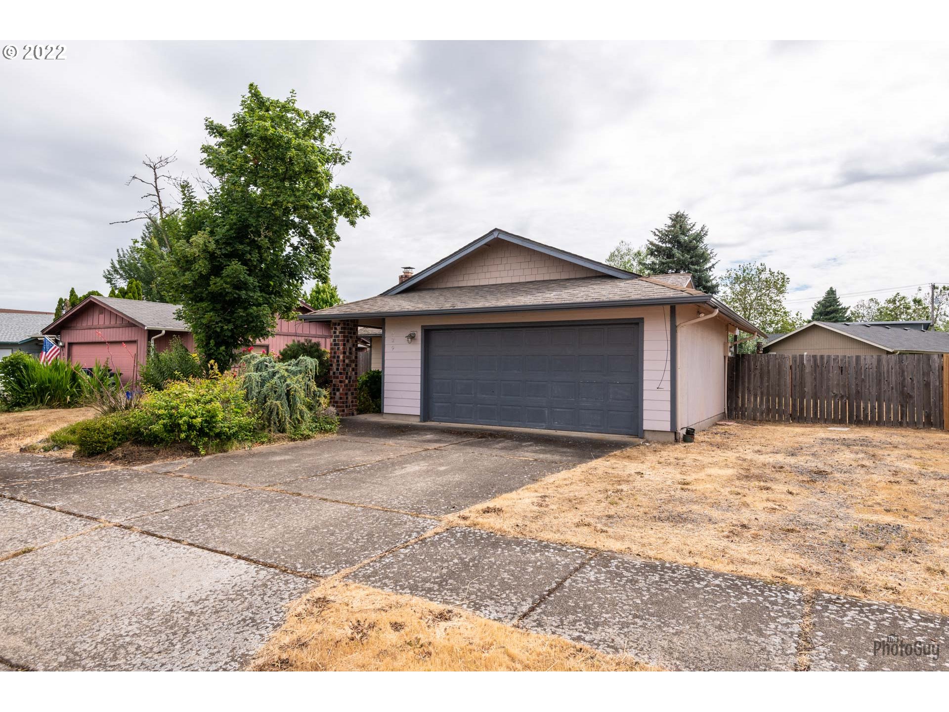 529 Sandstone Way Eugene, OR 97402 - Photo 2 of 19 a front view of a house with a yard and garage