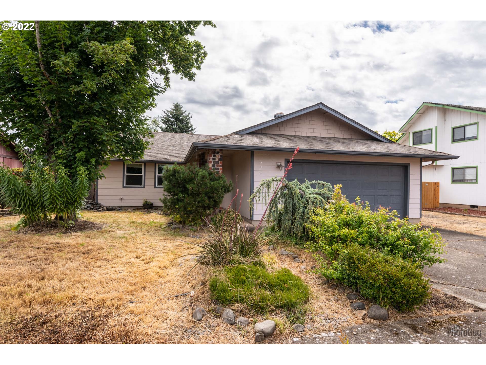 529 Sandstone Way Eugene, OR 97402 - Photo 3 of 19 a front view of a house with garden
