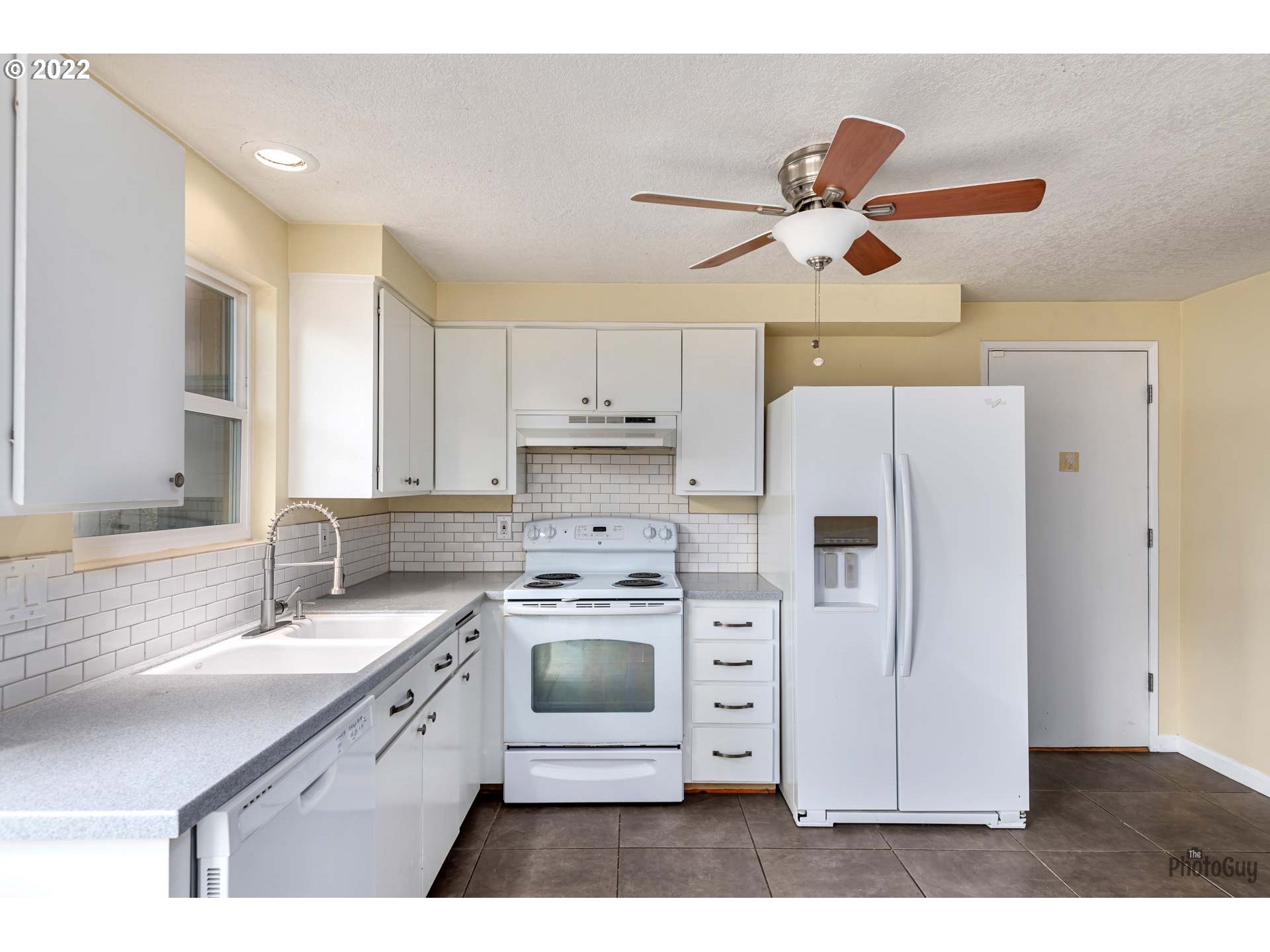 529 Sandstone Way Eugene, OR 97402 - Photo 8 of 19 a kitchen with kitchen island a white cabinets and refrigerator