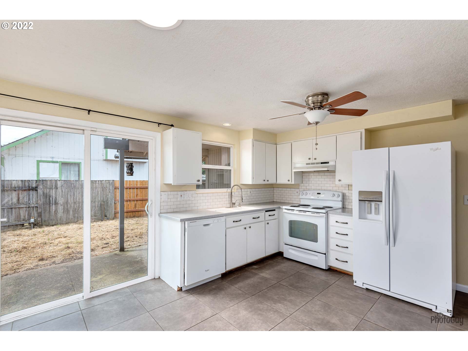 529 Sandstone Way Eugene, OR 97402 - Photo 9 of 19 a kitchen with white cabinets and white appliances