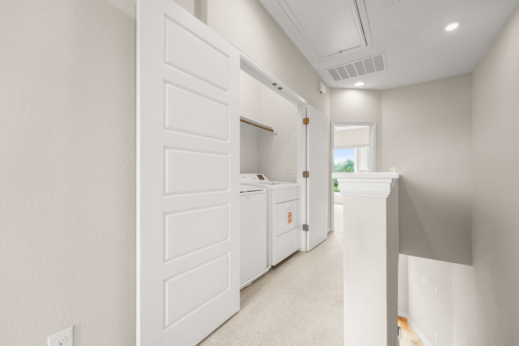 4403 Swift Path Austin, TX 78741 - Photo 17 of 32 Dedicated laundry area featuring white panel doors, built-in shelving, and a light-colored carpeted floor