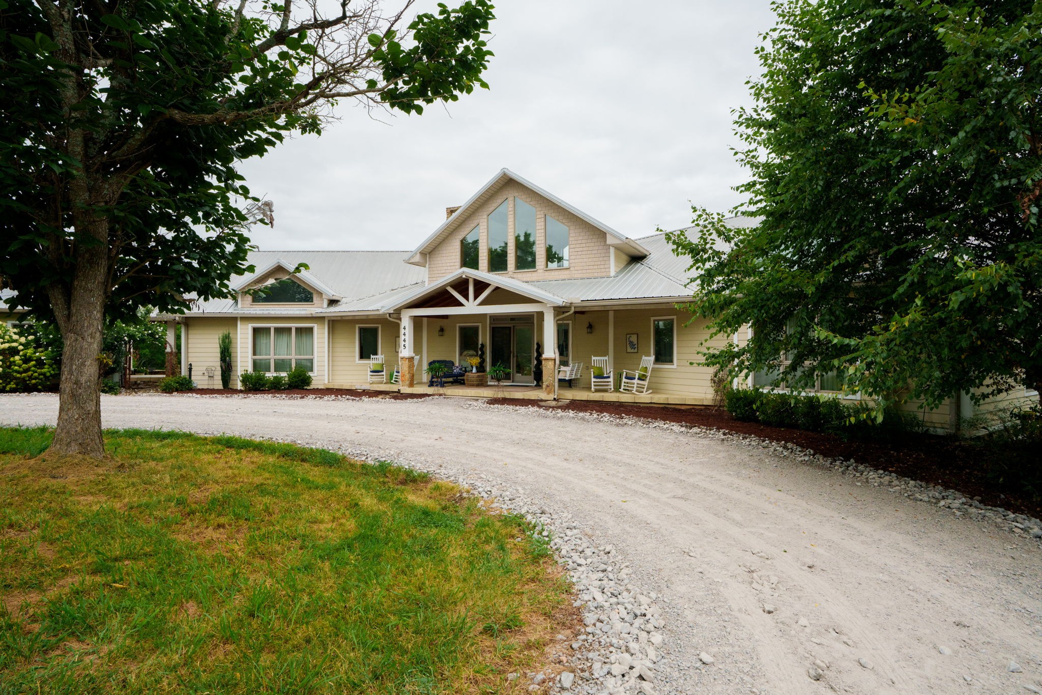4445 Hurricane Ridge Road Smithville, TN 37166 - Photo 3 of 84 a front view of a house with a garden