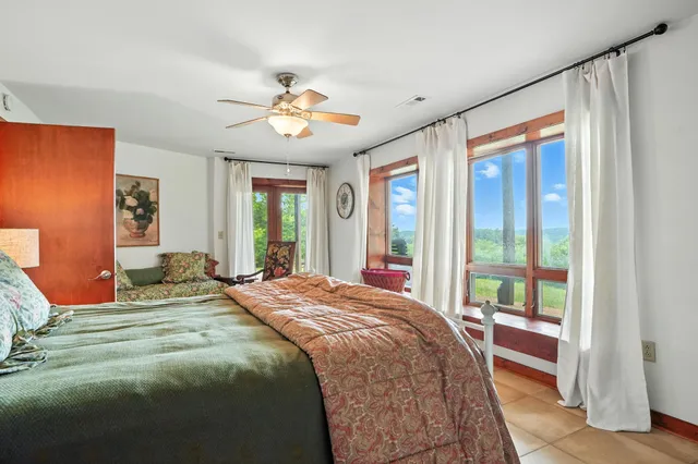 an aerial view of a house with a yard and lake view