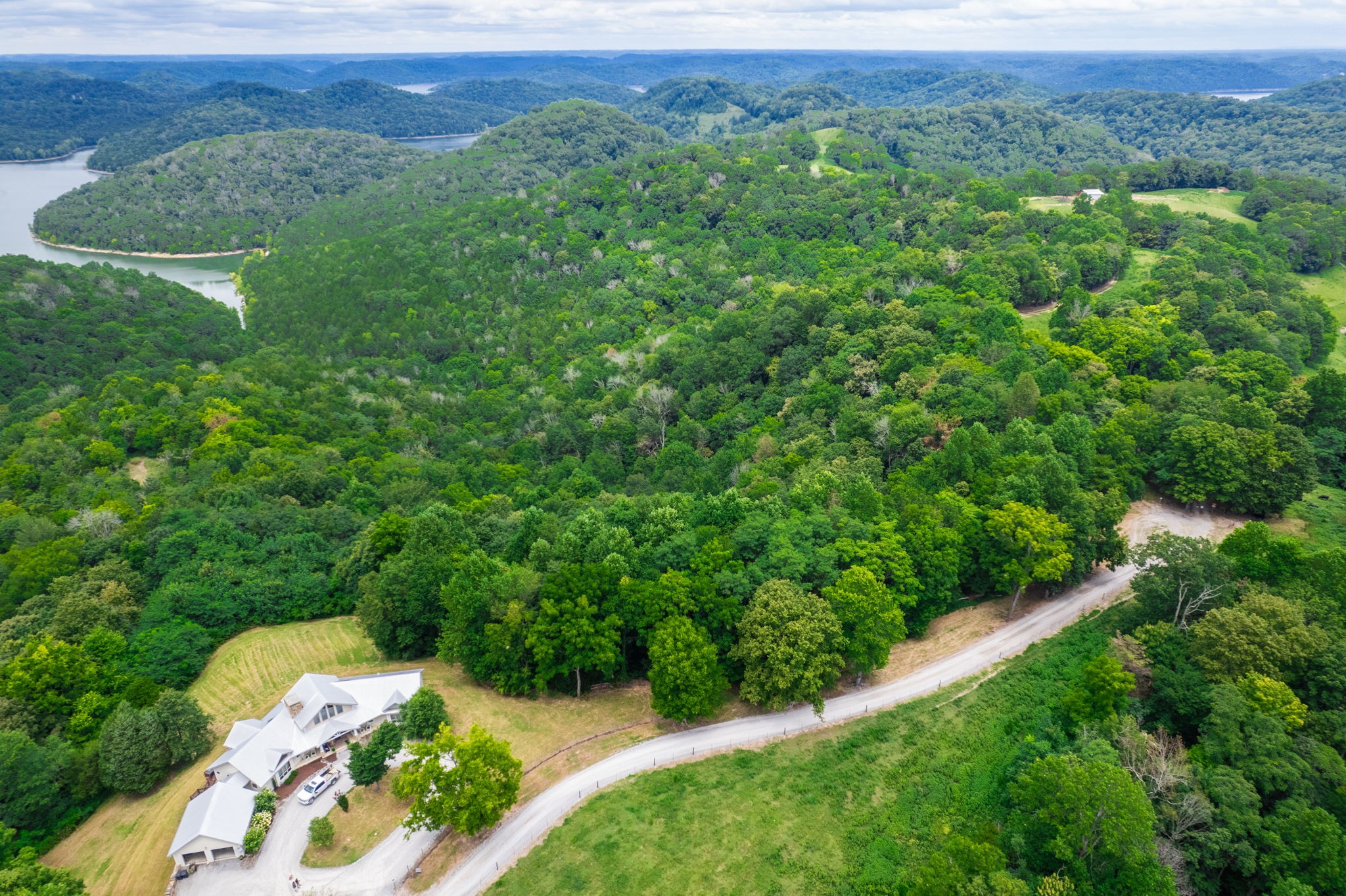 4445 Hurricane Ridge Road Smithville, TN 37166 - Photo 76 of 84 an aerial view of a house with a yard and lake view