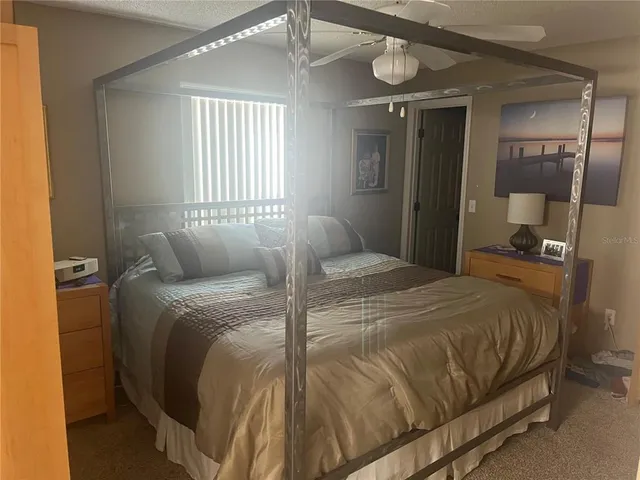 a bedroom with a bed and a mirror