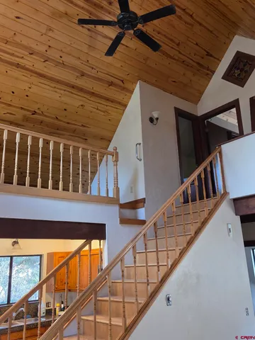 a view of staircase with lots of wooden floor and a dining table