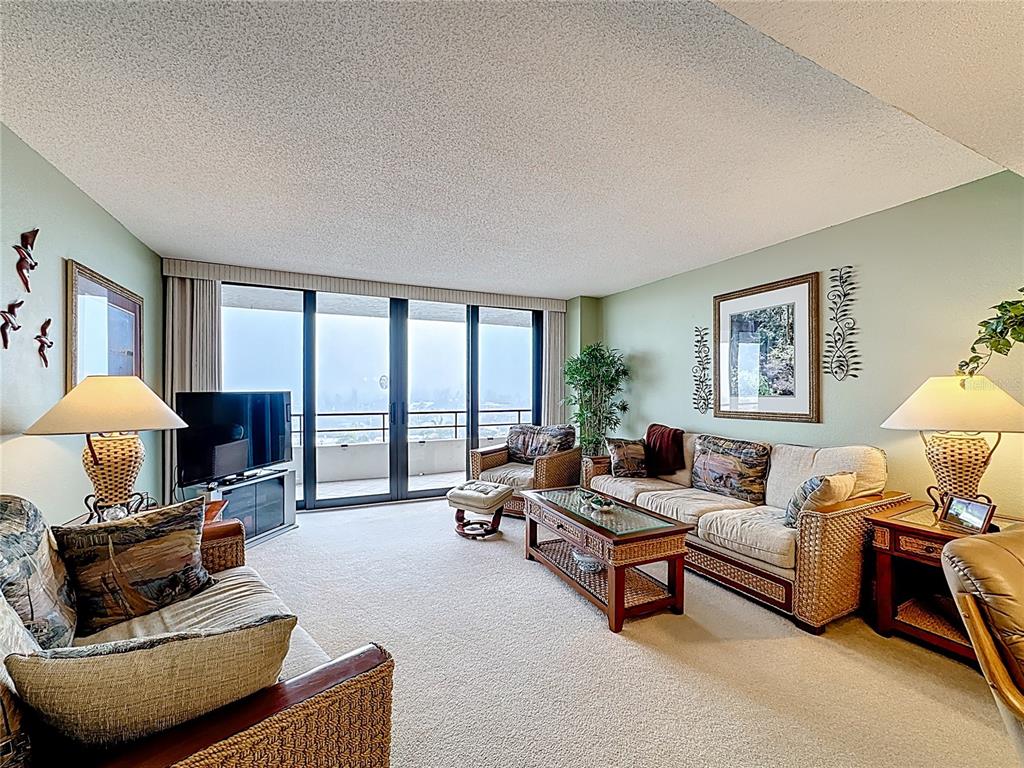 6415 Midnight Pass Road, Unit 705 Sarasota, FL 34242 - Photo 12 of 44 a living room with furniture and a large window