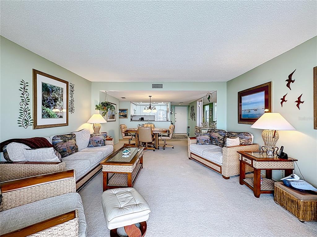 6415 Midnight Pass Road, Unit 705 Sarasota, FL 34242 - Photo 14 of 44 a living room with furniture and a lamp