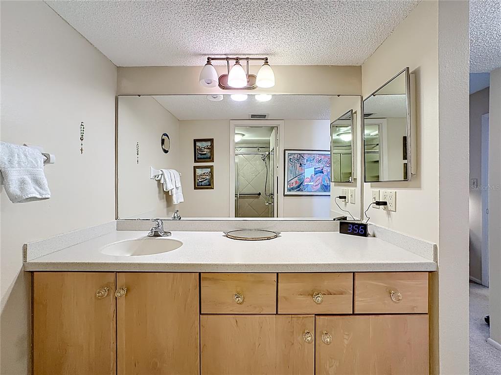6415 Midnight Pass Road, Unit 705 Sarasota, FL 34242 - Photo 20 of 44 a bathroom with a sink and a mirror