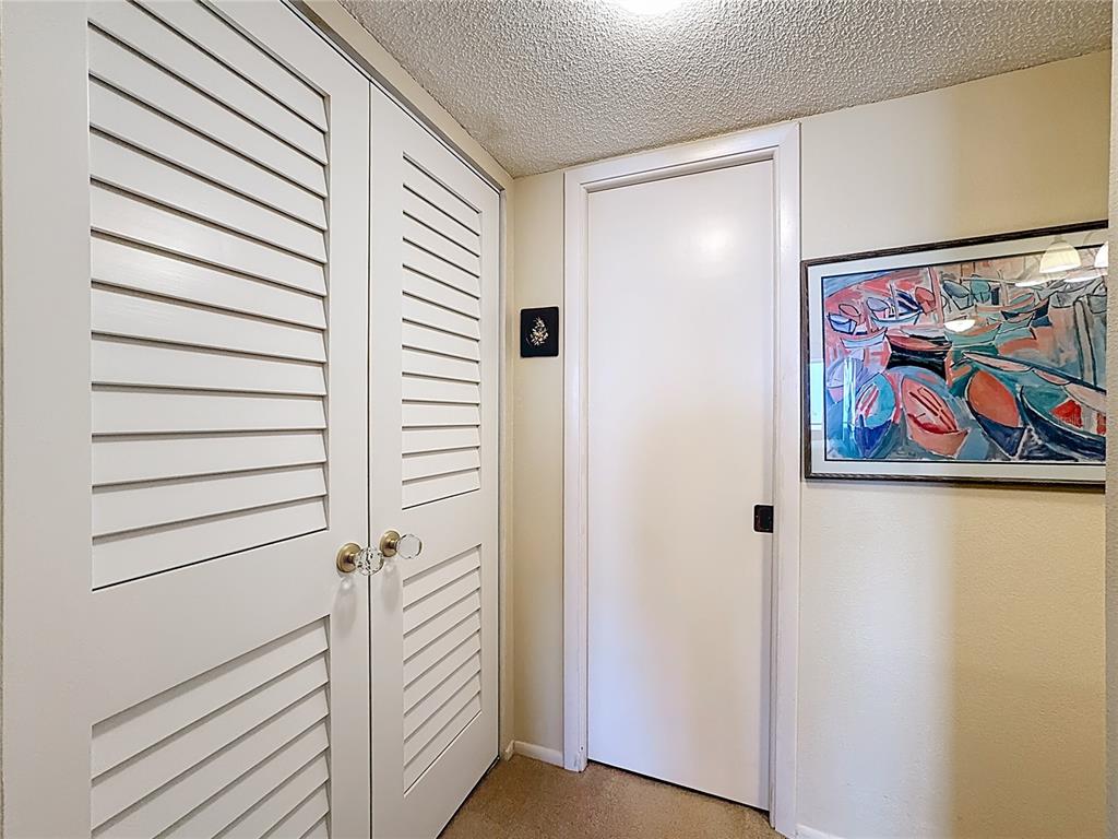 6415 Midnight Pass Road, Unit 705 Sarasota, FL 34242 - Photo 26 of 44 a view of a hallway with front door