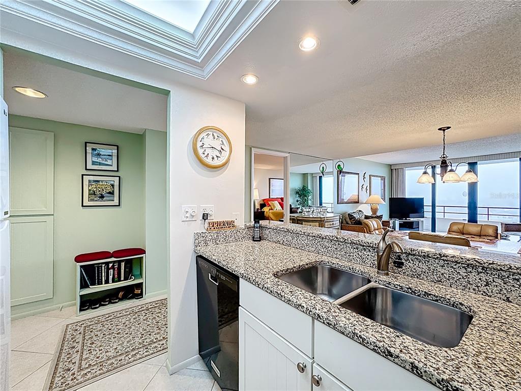 6415 Midnight Pass Road, Unit 705 Sarasota, FL 34242 - Photo 4 of 44 a kitchen with a sink and a refrigerator