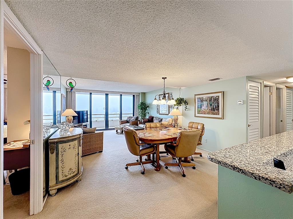 6415 Midnight Pass Road, Unit 705 Sarasota, FL 34242 - Photo 5 of 44 a dining room with furniture and chandelier